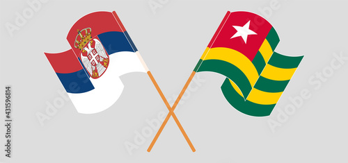 Crossed and waving flags of Serbia and Togo