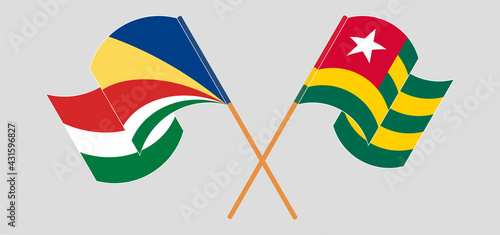 Crossed and waving flags of Seychelles and Togo
