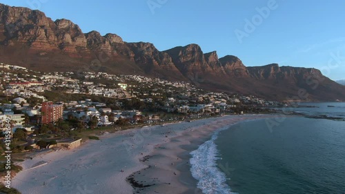 Aerial view of Camps Bay Beach and Twelve Apostoles mountain range at sunset in Cape Town, Western Cape, South Africa.	