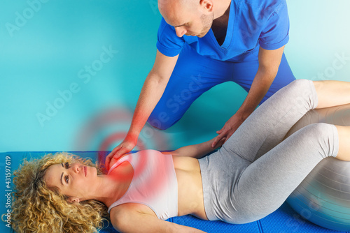 Girl performs exercises with a physiotherapist. Cyan background