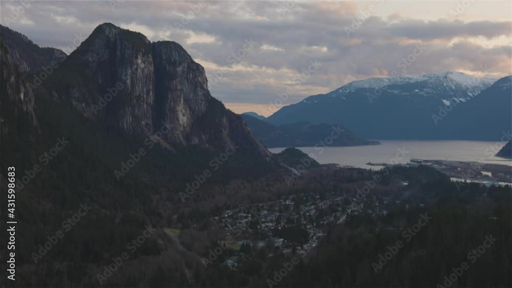 Squamish, North of Vancouver, British Columbia, Canada. View from the top of the Mount Crumpit of a small town surrounded by Canadian Mountain Landscape. Spring Sunset Squamish, North of Vancouver, British Columbia, Canada. View from the top of the Mount Crumpit of a small town surrounded by Canadian Mountain Landscape. Spring Sunset