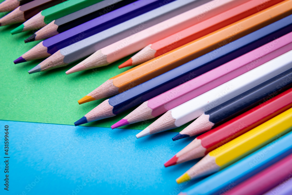 Colorful pencil set on blue and green background Colorful pencil set on blue and green background