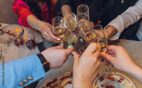 Clinking glasses with alcohol and toasting, party. photo