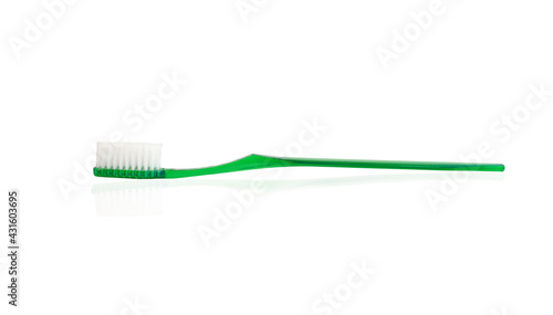 green plastic toothbrush on white background