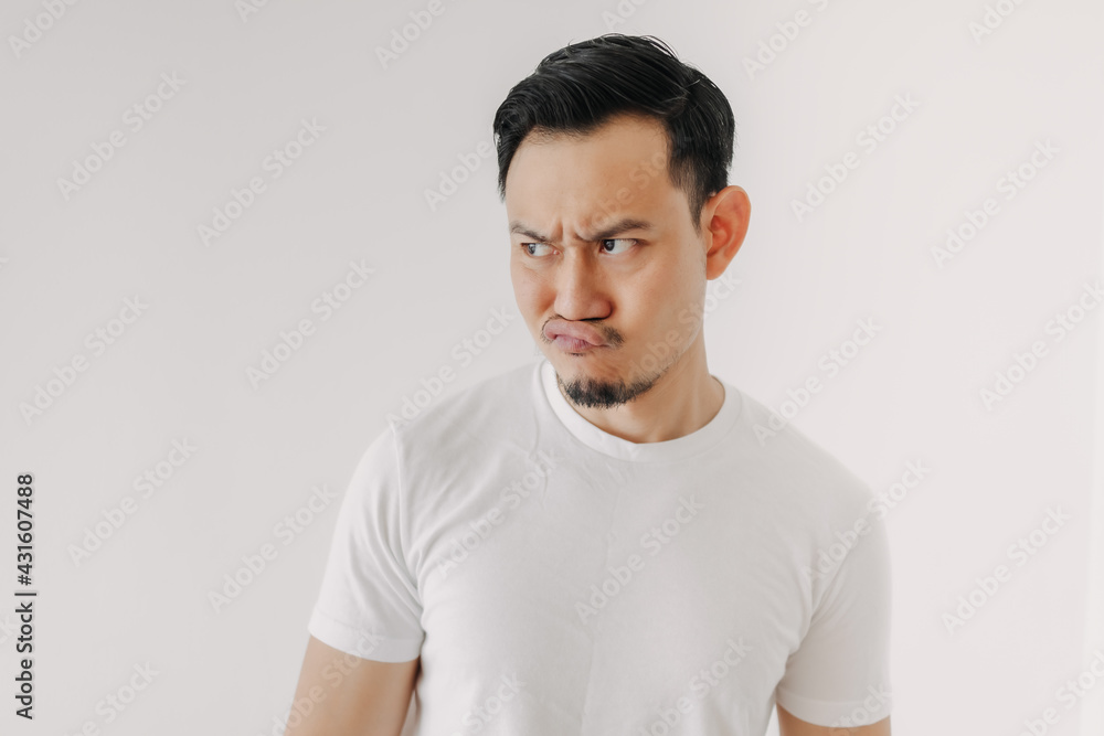 Grumpy face Asian man in white t-shirt isolated on white background. Grumpy face Asian man in white t-shirt isolated on white background.