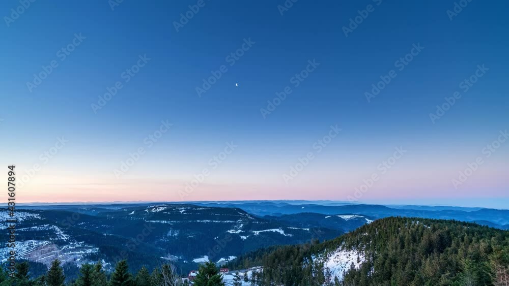 Time-lapse, moon disappears and sunrise illuminates Feldberg (Black Forest) in Germany. Time-lapse, moon disappears and sunrise illuminates Feldberg (Black Forest) in Germany.