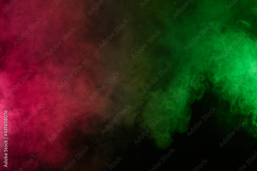 Fototapeta premium Smoke in red-green light on black background