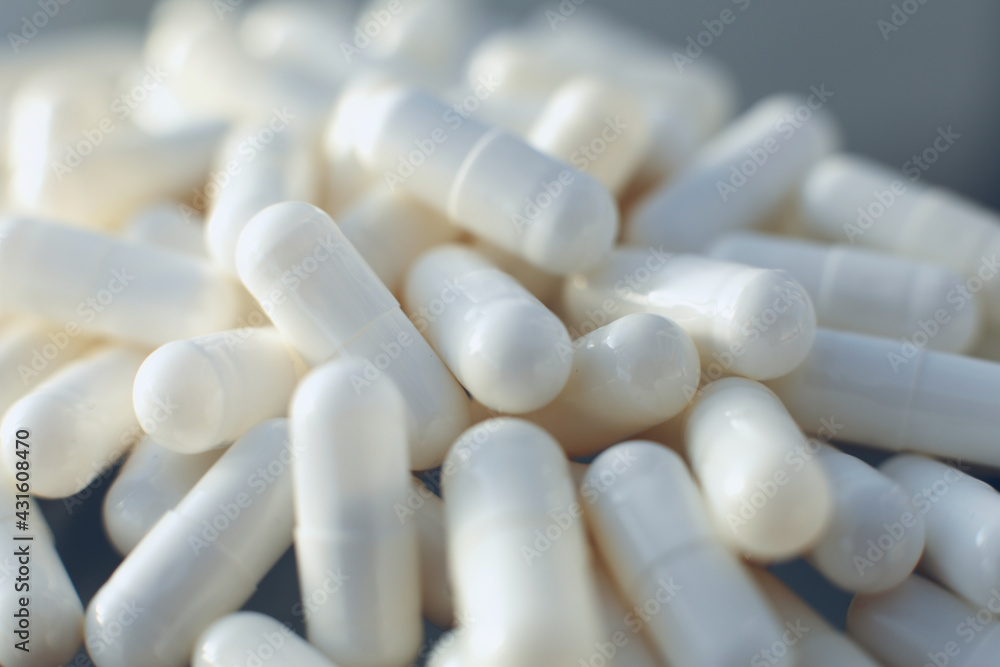 White pills on glass table. Close up White pills on glass table. Close up