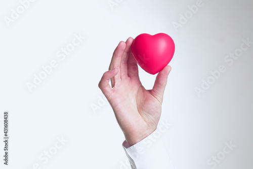 Fototapeta Naklejka Na Ścianę i Meble -  Doctor holding heart in his hands on white background