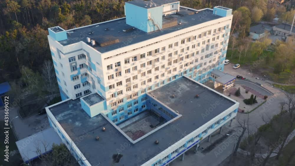 Hospital building exterior on a sunny day. Aerial side view of a clinic windows at sunset