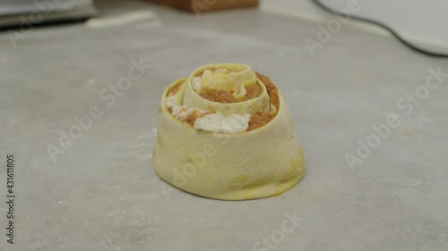 Rolled lasagne on kitchen cooking table. Close up slow motion shot. photo