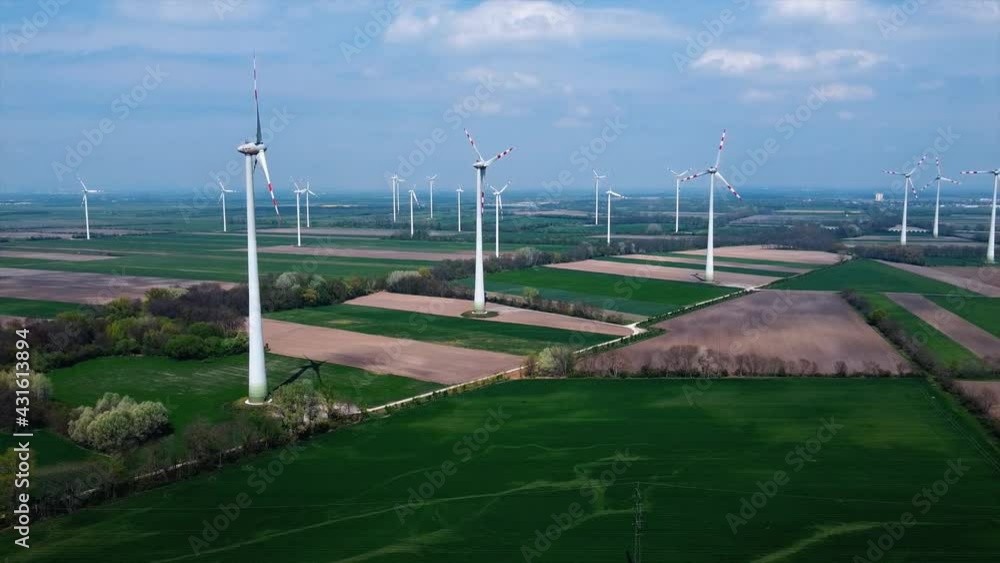 AERIAL - Wind turbines in a wind energy farm in Austria, wide shot slow left AERIAL - Wind turbines in a wind energy farm in Austria, wide shot slow left