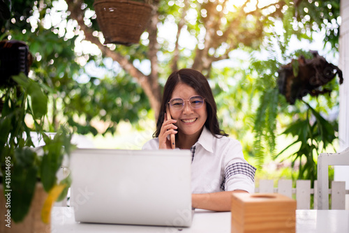 Happy asian woman using mobile phone and working at home,Work from home,New normal concept