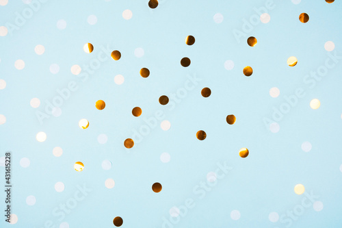 Festive light blue background with golden confetti