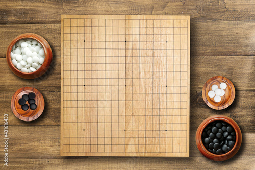 Goban, Baduk, Weiqi or Maklom - Traditional asian strategy board game. black and white stones boardgame - top view photo