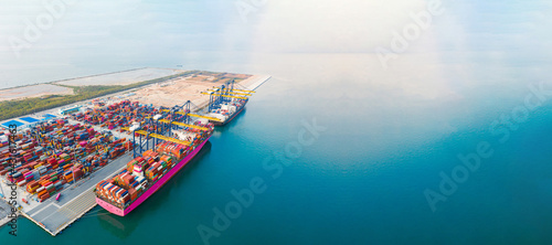 Aerial top view of containers cargo ship. business logistic transportation sea freight, cargo ship, cargo container in deep sea port at industrial estate for import export around in the world