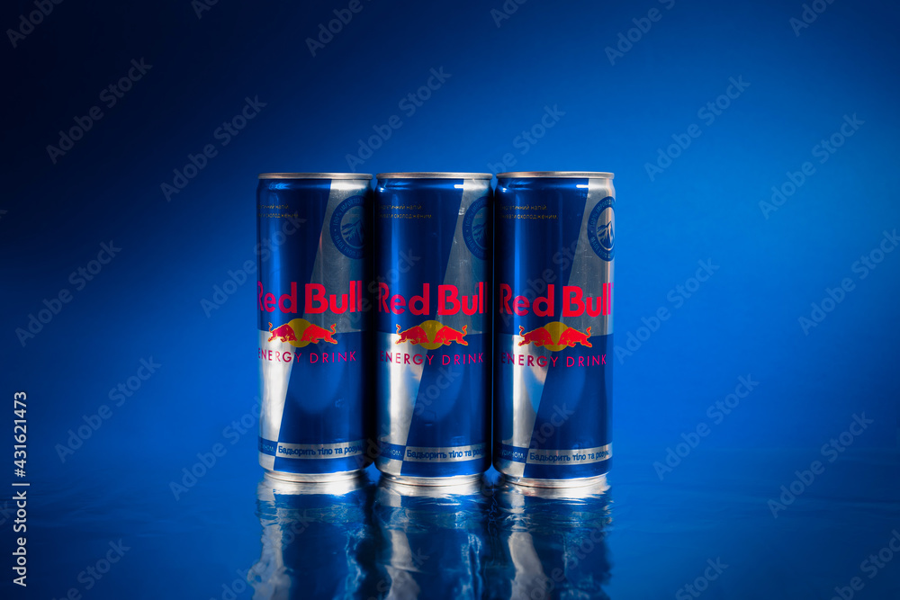 Kiev, Ukraine - july 11, 2021: Three cans of Red Bull energy drink on a blue  background Photos | Adobe Stock