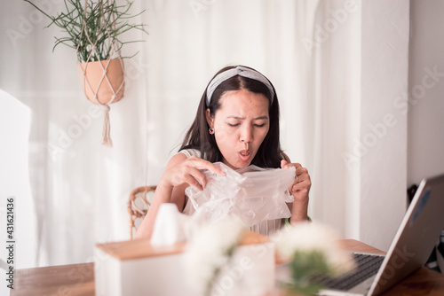 Sick asian woman puking into plastic bag at home,Nausea,Indigestible photo