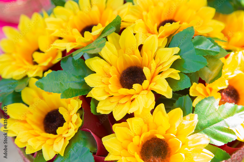 Fototapeta premium Floral background. Lot of artificial flowers in colorful composition,closeup flowers background