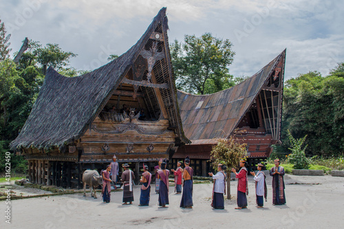 Samosir, Indonesia – May 7, 2015: Tortor Dance Performance, one of the typical dances of the Batak tribe, for tourists on Samosir Island Toba Lake, North Sumatera, Indonesia photo