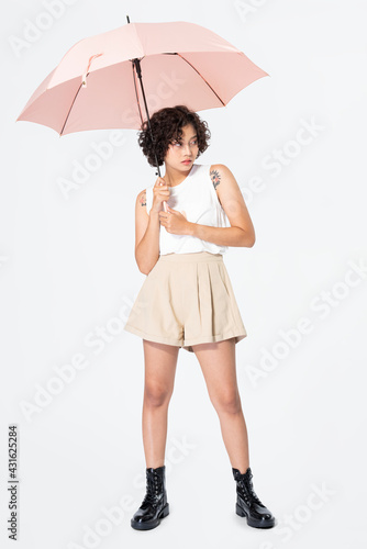 Woman holding pink umbrella casual apparel