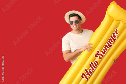 Young man holding inflatabl...