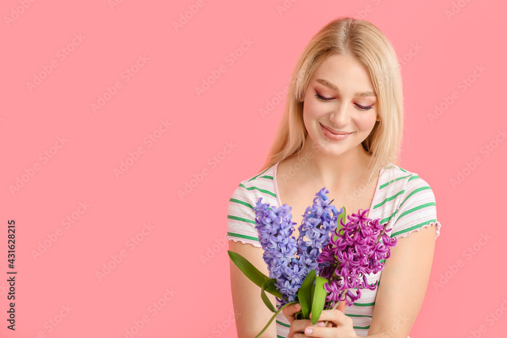 Beautiful young woman with hyacinth flowers on color background Beautiful young woman with hyacinth flowers on color background