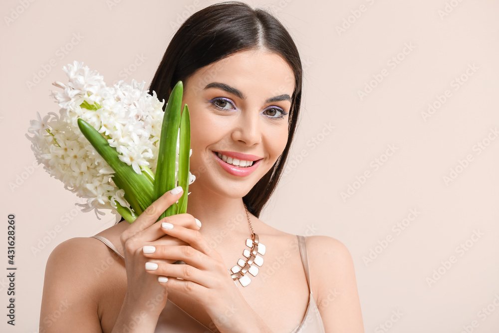 Beautiful young woman with hyacinth flowers on light background Beautiful young woman with hyacinth flowers on light background