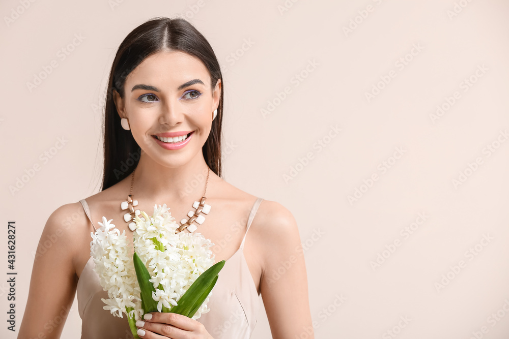 Beautiful young woman with hyacinth flowers on light background Beautiful young woman with hyacinth flowers on light background