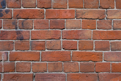 Weathered stained old brick wall background. grange