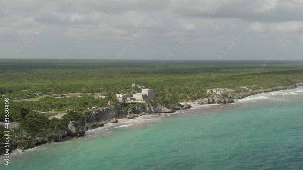 Aerial Shot Of People Exploring Famous Tulum Ruins On Sunny Day, Drone Flying Forward Towards Tourists At Historic Landmark Against Cloudy Sky Aerial Shot Of People Exploring Famous Tulum Ruins On Sunny Day, Drone Flying Forward Towards Tourists At Historic Landmark Against Cloudy Sky