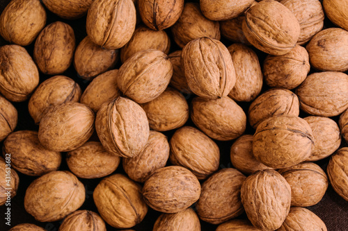 Natural walnut background pattern texture. Abstract walnuts heap pattern background