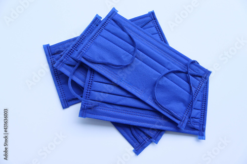 Face masks cloth blue wearing to anti virus protection corona COVID-19 isolated on white background closeup.
