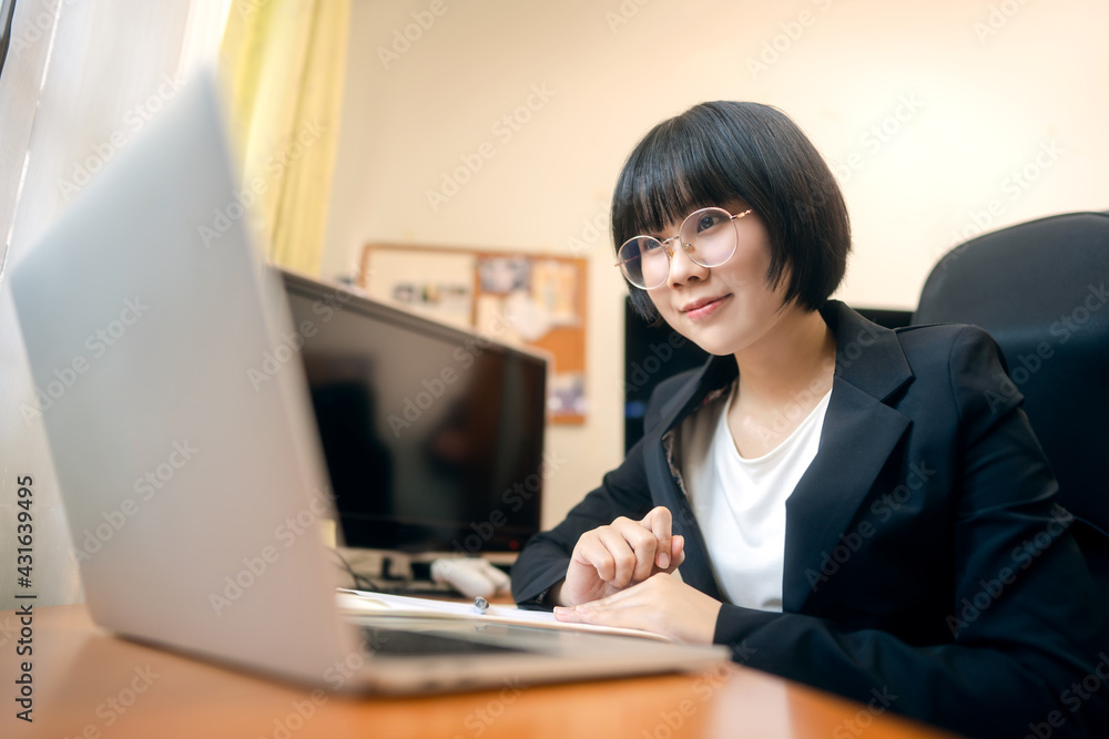 Young adult asian woman using laptop computer for video call work at home on day. Young adult asian woman using laptop computer for video call work at home on day.