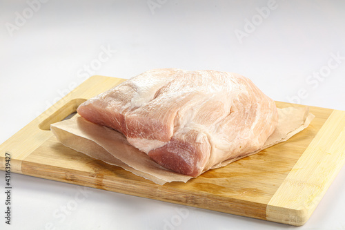 Raw pork fillet over board