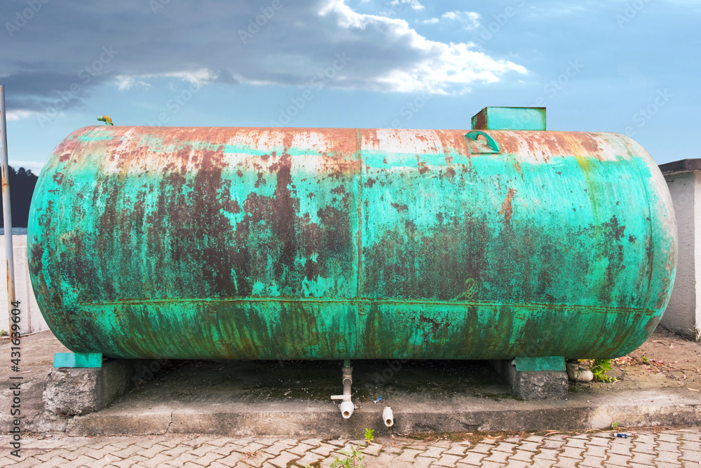 Old rusty green metal tank wagon on a sky background Old rusty green metal tank wagon on a sky background