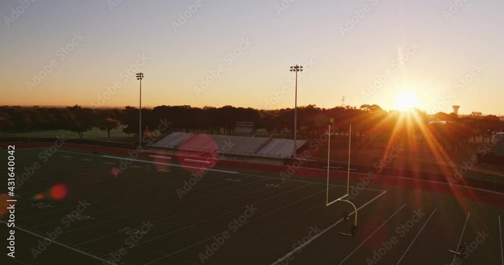Gorgeous sunrise aerial of a empty high school sports stadium at sunrise. Gorgeous sunrise aerial of a empty high school sports stadium at sunrise.