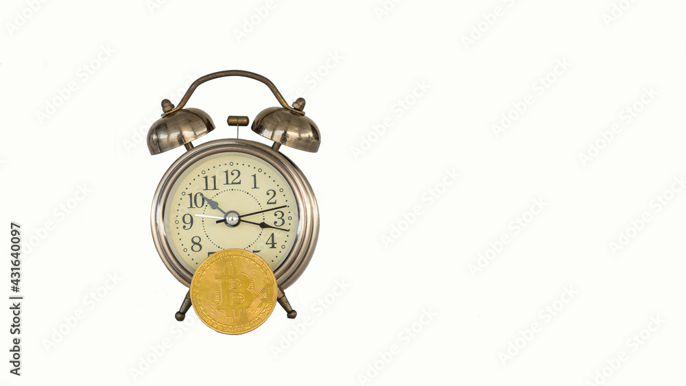 Bitcoin, digital currency placed in front of the clock, the concept of Bitcoin mining. Bitcoin, digital currency placed in front of the clock, the concept of Bitcoin mining.