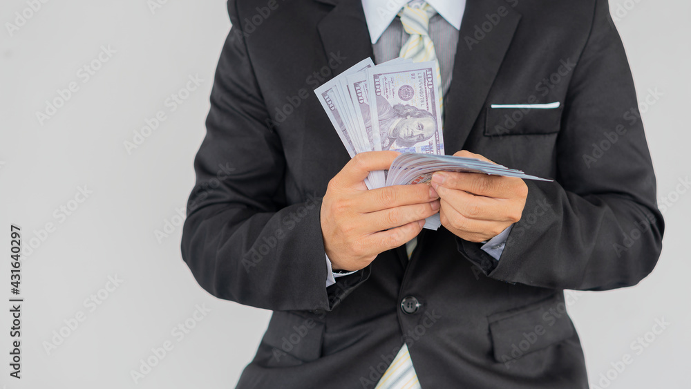 Successful businessman standing on the white background of money Successful businessman standing on the white background of money