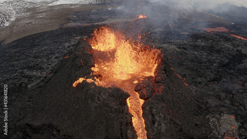 lava eruption volcano with snowy mountains, Aerial view Hot lava and magma coming out of the crater, April 2021 