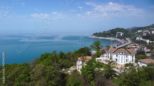 Aerial view of a beautiful mansion on the beach in a coastal town. Sochi, Russia.