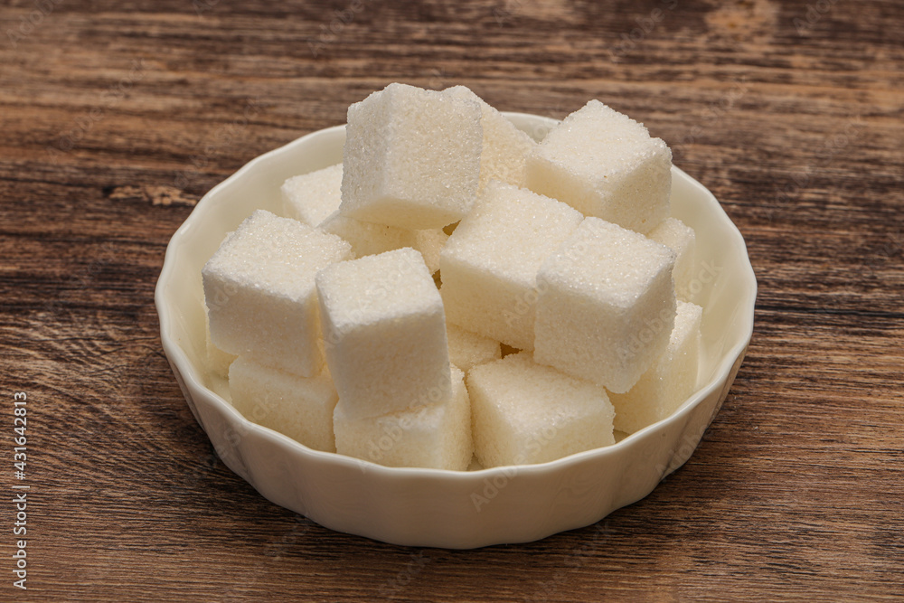 Refined white sugar cubs in the bowl Refined white sugar cubs in the bowl