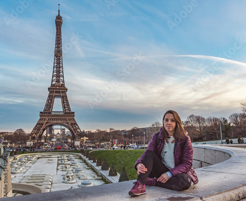 Young girl on vacation in paris with the Eiffel tower in the background
