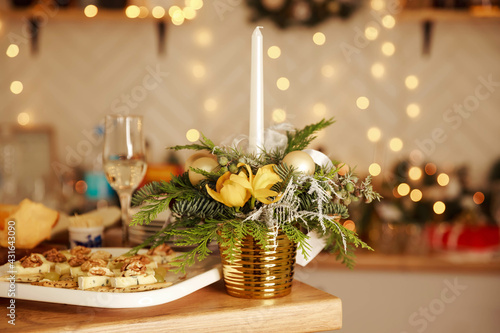 Burning candle and glasses of wine on wooden table. Table set for an event party. Decorated table at luxury event. Relaxing time in evening after work hard. Christmas romantic dinner. Celebration