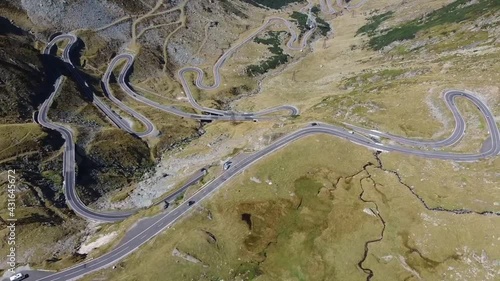 The famous high altitude alpine road named Transfagarasan crossing the Fagaras Mountains , in Transylvania , part of the Carpathian range, a favorite tourist and travel destination , aerial drone foot