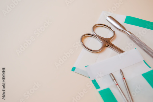 Professional manicure set of tools in a plastic bag for sterilization. Scissors, cutters for removing material and processing cuticles.