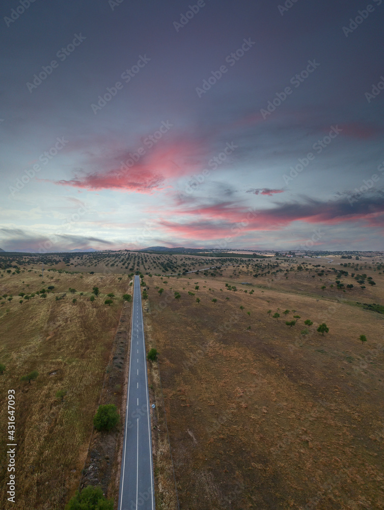 Aerial view of a country road at the sunset