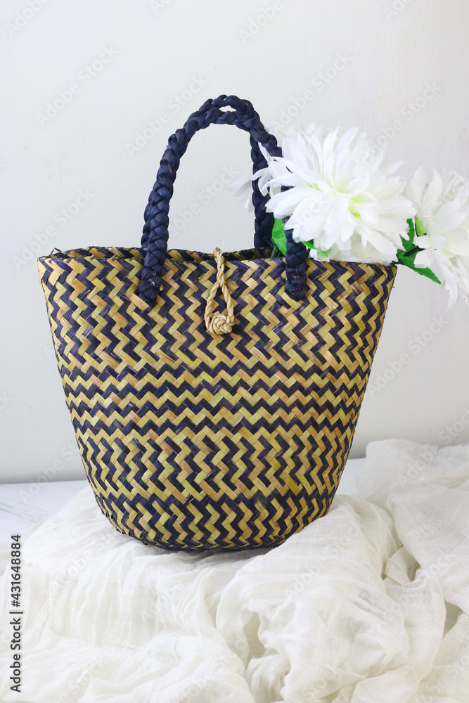 Tas anyaman purun, Indonesian traditional woven tote bag from Banjarmasin, South Kalimantan. Isolated white background. Bright concept product photography. Tas anyaman purun, Indonesian traditional woven tote bag from Banjarmasin, South Kalimantan. Isolated white background. Bright concept product photography.