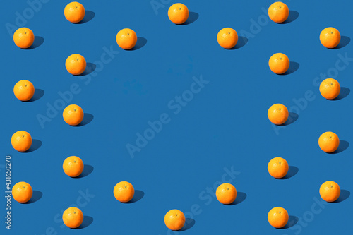 Orange fruit pattern on blue background. Space for text. Copy space.