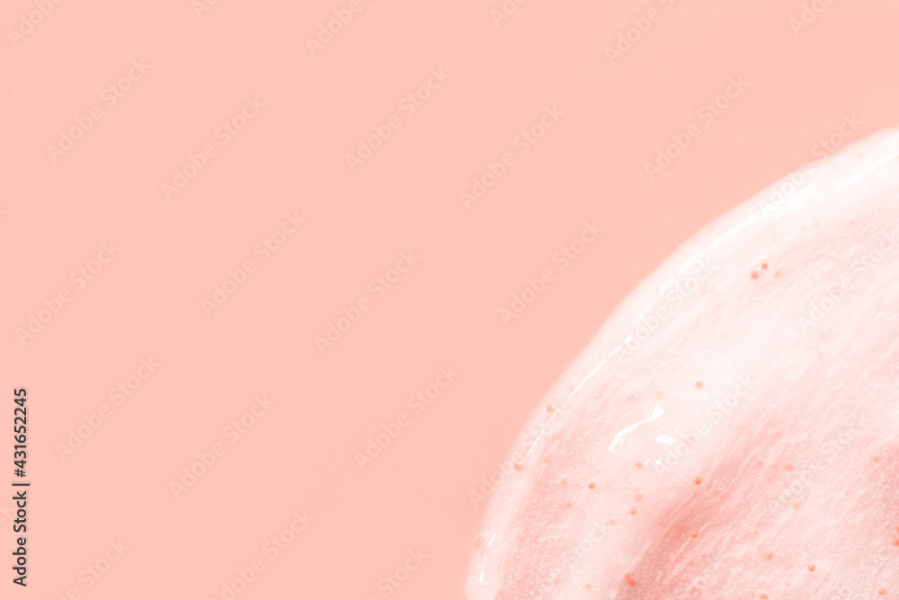 Fototapeta premium The texture of a scrub or shower gel on a pink background.